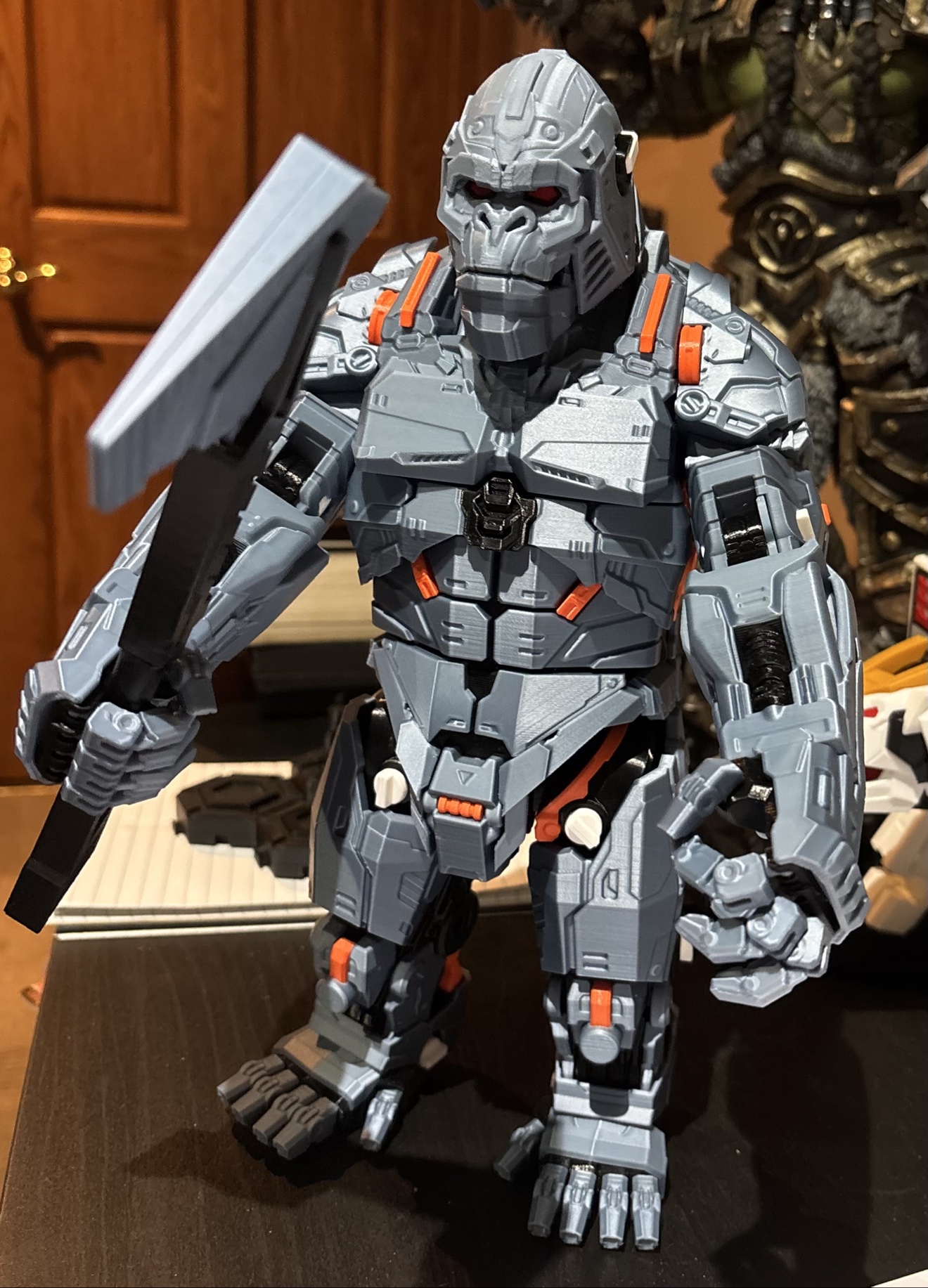 Large grey and orange mech King Kong 3D print holding an axe